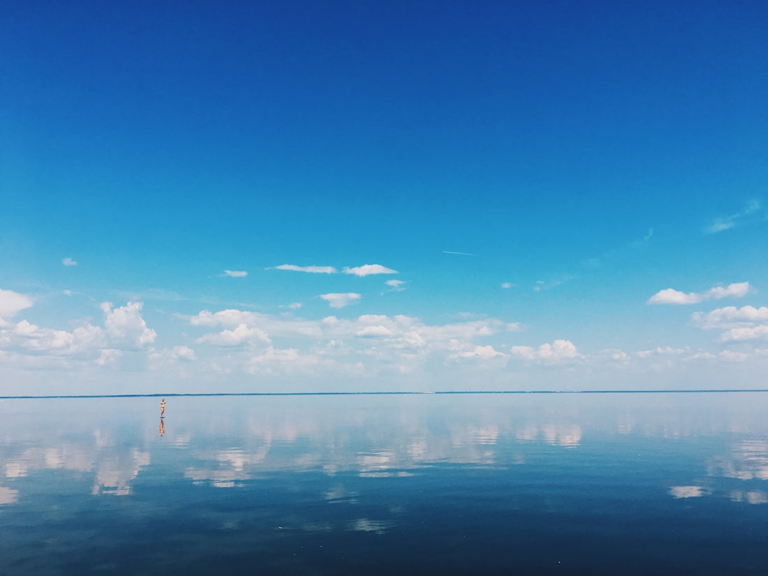 body of water under blue sky