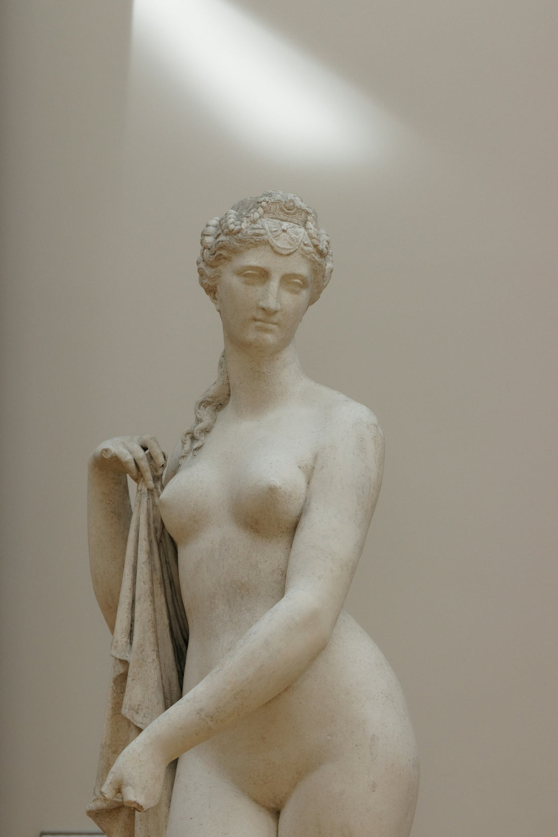 white ceramic statue of a woman