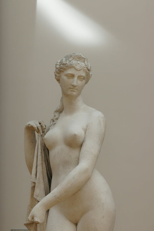 white ceramic statue of a woman