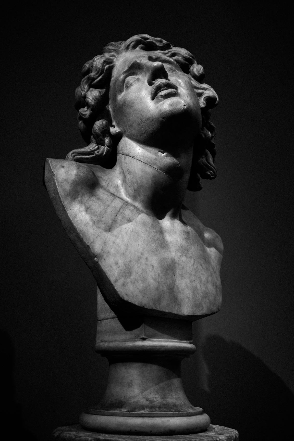 A black and white photo of a bust of a man