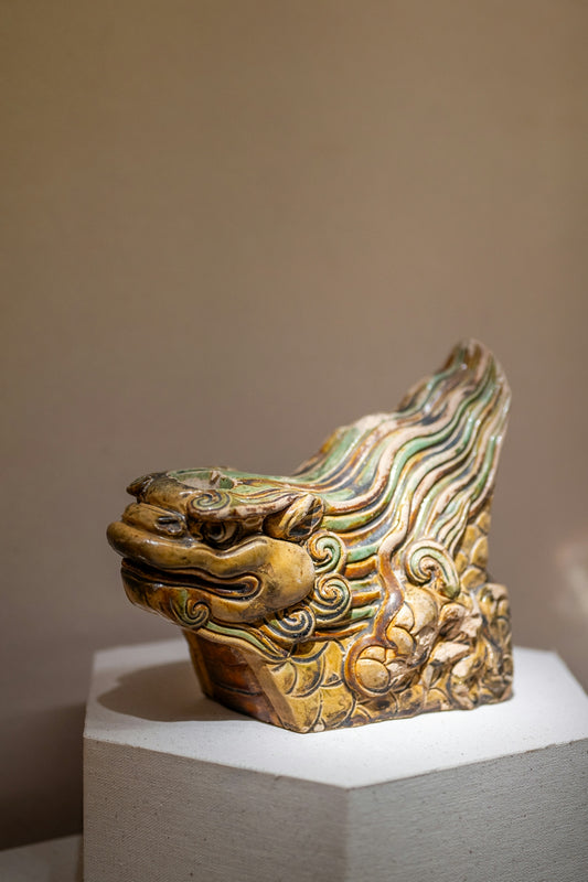 Ancient ceramic dragon head sculpture with green and yellow glaze